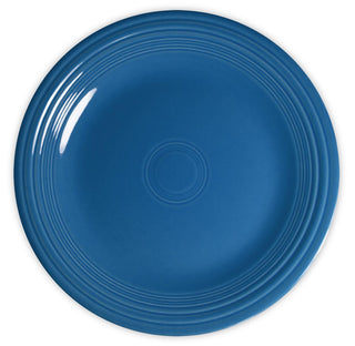 A round, blue ceramic plate with concentric raised rings near the edge, shown from above on a white background.