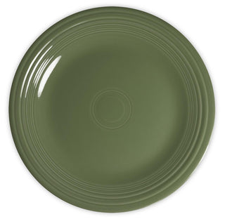 A round, green ceramic plate with a smooth finish and raised concentric circles near the rim, shown from a top-down view.