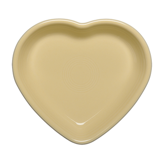 An ivory Retired Fiesta 7 1/2 Inch Medium Heart Shaped Bowl (17 oz) with smooth edges and a glossy finish, crafted from lead-safe china by Fiesta, viewed from above against a white background.