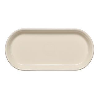 The Fiesta 11 7/8 Inch Oblong Serving Platter in Linen features a smooth, cream-toned finish with a subtle circular pattern and is microwave safe—combining style and practicality for everyday use.