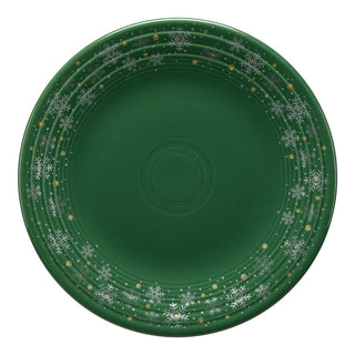 The Fiesta Snowflake Classic Rim 9 Inch Luncheon Plate features a green glaze with white snowflakes and gold dots along the rim for a festive, wintry look. Proudly made in the USA.