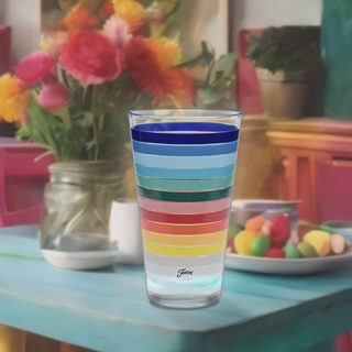 A 16 oz. All Colors Stripe Cooler Glass by Moderne Glass sits on a blue table with flowers and eggs, creating a bright scene with Fiesta Dinnerware—proudly made in the USA. Set includes 4 cooler glasses.