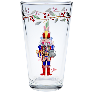 Bring festive cheer to your table with the Moderne Glass Nutcracker The Giver 16 oz. Cooler Glass Set of 4, featuring a vibrant nutcracker soldier design plus red berry and green leaf accents—perfect for your holiday collection or dinnerware set.