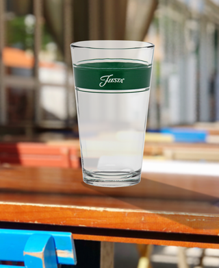 A glass of water sits on the table, perfectly chilled in a 16 oz. Fiesta® Frame Cooler Jade from Moderne Glass—sold as a set of 4 and made in the USA.