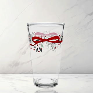 The Moderne Glass Holly Berry Christmas Garland 16 oz. Cooler Glass Set of 4 features clear glass decorated with a red ribbon, green pine needles, and red berries—made in the USA and perfect for festive gatherings.