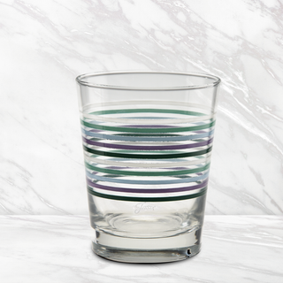 The Moderne Glass Fiesta Lavender Bloom Thin Stripe 15 oz. Tapered Double Old Fashion glasses, sold as a set of 4, feature horizontal blue, teal, and gray stripes and are pictured on a white marble surface with a matching background.