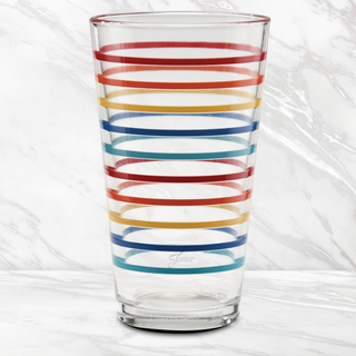 The 16 oz. Fiesta Vibrant Thin Stripe Cooler Glass by Moderne Glass features horizontal red, yellow, blue, and orange stripes and is set against a white marble background. Comes in a set of 4.