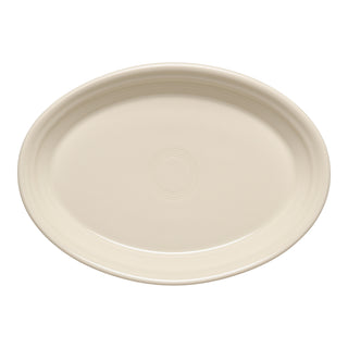 The Fiesta Linen 9 5/8 Inch Small Oval Serving Platter is off-white, oval-shaped, features a smooth surface with subtle circular patterns, is made in the USA, and is dishwasher safe.