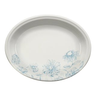 The Fiesta Botanical Floral Sky 11 5/8 Inch Medium Oval Serving Platter features delicate light blue floral designs along one edge, ideal for fans of botanical dinnerware.