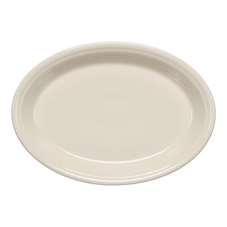 The Fiesta 13 5/8 Inch Large Oval Serving Platter in Linen features a smooth, glossy finish and a slightly raised rim. Made in the USA, this off-white platter by Fiesta is shown from above.