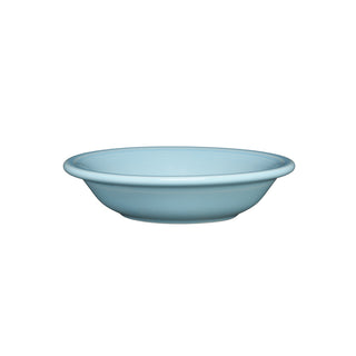 The Fiesta Sky Fruit Bowl is a light blue, shallow ceramic bowl made in the USA from durable vitrified china, featuring a slightly raised rim and shown against a plain white background.