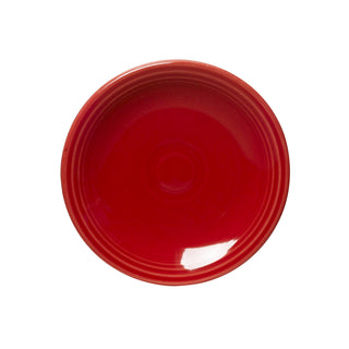 The Fiesta Retired Classic Rim 6 1/8 Inch Appetizer Plate in scarlet features a glossy finish and concentric raised lines near the rim. Made from durable, dishwasher safe china, it's shown from above on a white background.