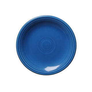 The Fiesta Retired Classic Rim 6 1/8 Inch Appetizer Plate in lapis blue features concentric ridges on the rim, is dishwasher safe for easy cleaning, and is perfect for serving appetizers.