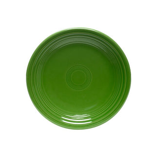 The Fiesta Retired Classic Rim 7 1/4 Inch Salad Plate in Shamrock is a glossy, bright green ceramic plate with raised circles near the rim, made in the USA and shown from a top view on a white background.