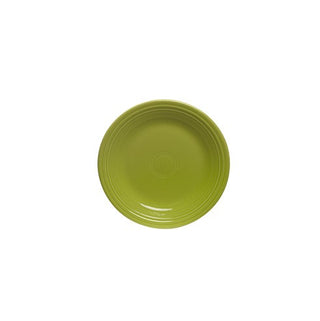 The Fiesta Retired Classic Rim 7 1/4 Inch Salad Plate in lemongrass is a glossy, round green ceramic plate with simple edge patterns, lead-safe china, proudly made in the USA and shown centered on a white background.