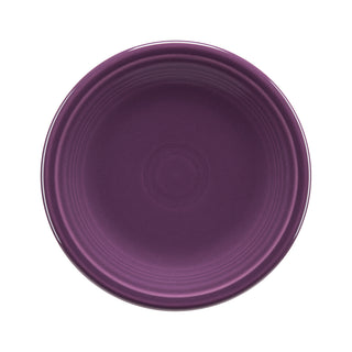 The Fiesta Retired Classic Rim 7 1/4 Inch Salad Plate in Mulberry features a smooth, deep purple surface with subtle concentric ridges near the rim. Made in the USA from lead-safe china.