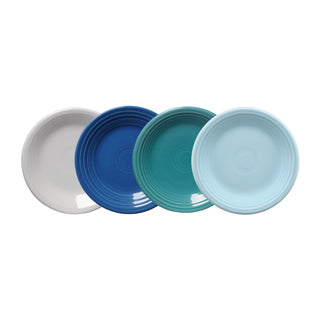 The Fiesta Mixed Coastal Blues Classic Rim 7 1/4 Inch Salad Plate Set of 4 features solid white, dark blue, teal, and light blue plates, each with a raised circular rim pattern for a timeless coastal look.