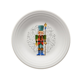 The Nutcracker Luncheons Set of 2 by Fiesta includes white vitrified china plates with a colorful Nutcracker design, musical notes, and festive swirls in the center. Dishwasher safe for easy cleaning.