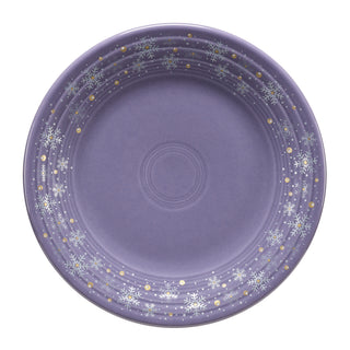 The Fiesta Lavender Snowflakes Classic Rim 9 Inch Luncheon Plate features white snowflakes and gold dots on lavender—festive, USA-made dinnerware, shown on a white background.