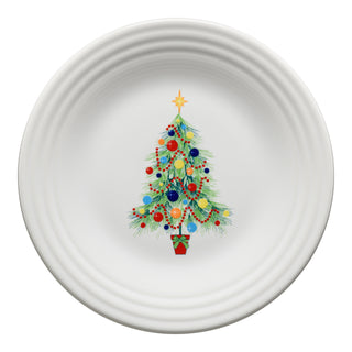 The Fiesta Retired Christmas Tree on White Classic Rim 9 Inch Luncheon Plate features a festive tree with ornaments, lights, and a star in a red pot. Made from lead-safe china in the U.S.A., it's perfect for holiday gatherings.