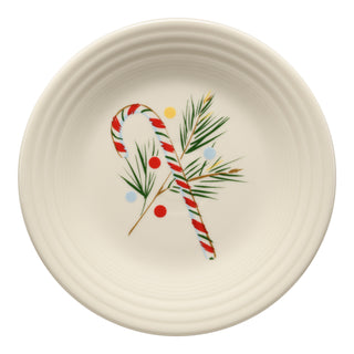 The Fiesta Jolly Christmas Candy Cane Classic Rim 9 Inch Luncheon Plate, made in the USA, features a festive design with a red and white candy cane, green pine branches, and colorful yellow, blue, and red dots.