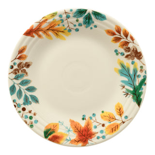 The Fiesta Autumn Fields Classic Rim 9 Inch Luncheon Plate is a round ceramic plate made in the USA, featuring colorful autumn leaves and blue berries on a cream background, with a plain center.