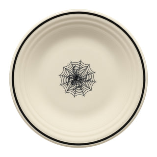The Fiesta Halloween Icon Spider Classic Rim 9 Inch Luncheon Plate features a round cream design with a thin black rim and a bold black spiderweb in the center.