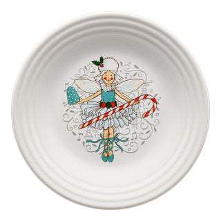 The Fiesta Nutcracker Sugar Plum Fairy Classic Rim 9 Inch Luncheon Plate features a festive fairy holding a candy cane and spatula, dressed in blue shoes, winter hat, and frilly dress, surrounded by swirls and holly.