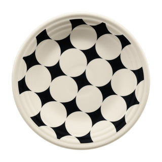 The Fiesta Black Kaleido Circles Classic Rim 9 Inch Luncheon Plate features bold interlocking black and white geometric shapes on cream, creating a striking optical illusion for modern dining.