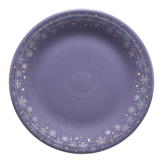 The Lavender Snowflakes Classic Rim 10 1/2 Inch Dinner Plate by Fiesta features white snowflakes, gold dots, and gray accents—an ideal festive dinnerware piece for winter table settings.