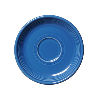 A retired Fiesta Classic Rim 5 7/8 inch saucer in lapis blue, featuring concentric circular ridges, is shown from above on a white background; made in the USA.
