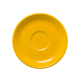 A Fiesta Retired Classic Rim 5 7/8 Inch Saucer in Daffodil, featuring a central circular indentation, is shown from above on a white background.