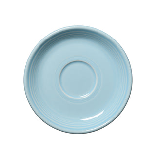 A retired Fiesta Classic Rim 5 7/8 inch saucer in sky, featuring concentric circular ridges and a recessed center. Viewed from above on a white background. Signature Fiesta quality, proudly made in the USA.