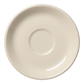 A top view of the Retired Classic Rim 5 7/8 Inch Saucer by Fiesta in Linen shows a plain, round off-white design with a subtle center ring and concentric grooves—crafted with classic style and made in the USA.