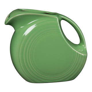 The Retired Fiesta 67 OZ Large Disk Pitcher by Fiesta features a meadow green color, modern rounded design, circular embossed patterns, integrated curved handle, small spout, and glossy lead-safe china. Made in the USA.