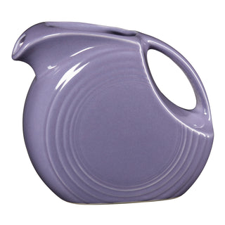 The Lavender 67 OZ Large Disk Pitcher by Fiesta features a smooth finish, wide spout, large circular handle, and raised rings—an iconic piece of lead-safe china displayed upright against a white background.
