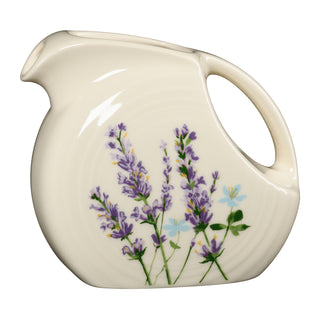 Fiesta Lavender Bloom Small Disk Pitcher in off-white ceramic, featuring a sprig of purple lavender flowers and dishwasher-safe construction.