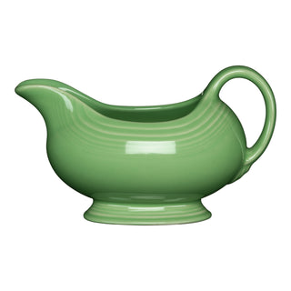 The Retired Fiesta 18 1/2 OZ Gravy Sauceboat in Meadow features a curved spout, handle, and pedestal base—perfect for serving sauces or gravy. Brand: Fiesta. Color: Meadow.