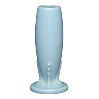 The Sky Bud Vase by Fiesta is a tall, glossy light blue vitrified china vase with curved sides, a narrow top opening, and an ornate, slightly flared base.