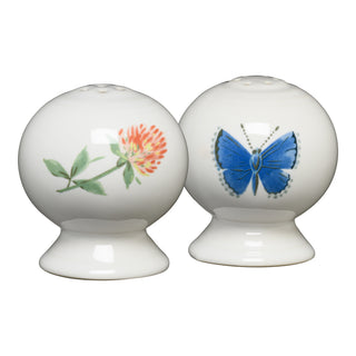 The Fiesta Retired Breezy Floral 2 5/8 Inch Salt and Pepper Shaker Set features round white vitrified china shakers—one with a red and green flower, one with a blue butterfly—proudly made in the USA.