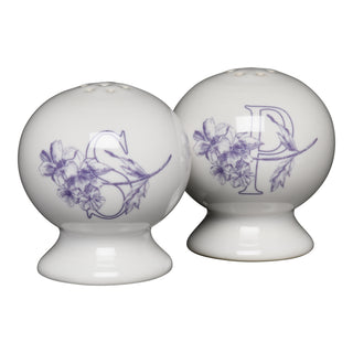 The Fiesta Botanical Floral Lavender 2 5/8 Inch Salt and Pepper Shaker Set features round white ceramic shakers with purple floral designs and bold S and P letters, making a charming addition to your collection.