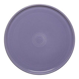 The Fiesta Lavender 12 Inch Round Baking and Serving Platter is a stylish, oven-safe ceramic plate with subtle concentric circles—perfect for serving pizza or other dishes.