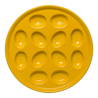 The Fiesta Retired Round Egg Serving Platter, 11 1/4 inch in Daffodil, is a USA-made, lead-safe china plate with twelve oval indents in a circular pattern—ideal for serving deviled eggs.