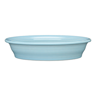 The Fiesta Retired Oval Baker, 10 1/4 in, 40 oz, in sky blue, features a wide rim and shallow depth; oven safe and ideal for elegant serving, shown on a white background.