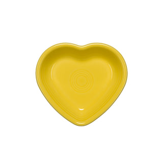 A vibrant yellow Fiesta Retired Small Heart Bowl, ideal for use as a jewelry holder or serving dish, is displayed on a white background in a top-down view.