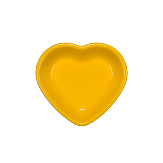 A bright yellow Fiesta Retired Small Heart Bowl, heart-shaped and ceramic, ideal as a jewelry holder, is displayed from above on a white background.