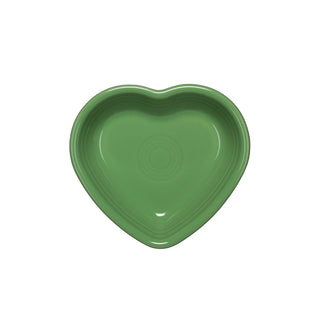 A green ceramic Retired Small Heart Bowl by Fiesta, heart-shaped and viewed from above on a white background—perfect for holding jewelry or as a charming hostess gift.