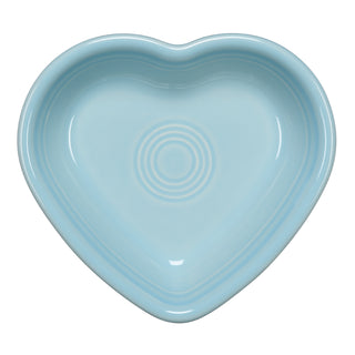 The Fiesta Retired Sky Small Heart Bowl is a light blue, heart-shaped ceramic dish made in the USA with a glossy finish and concentric circle patterns at the center.