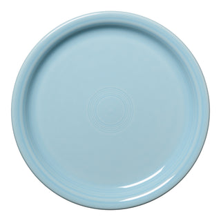 The Fiesta Bistro Coupe 9 Inch Luncheon Plate in sky features a round shape, slightly raised rim, and concentric circles at the center. Viewed from above on a white background. Made in the USA.