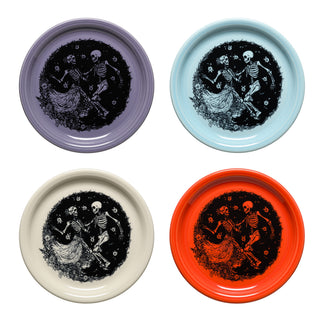 The Fiesta Skeleton Duet Mixed Colors Set includes four 9" Bistro Coupe luncheon plates, each in lavender, light blue, cream, and orange with black and white dancing skeleton artwork—a collectible set ideal for festive Halloween gatherings.